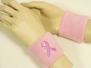 light pink sweatband with pink ribbon logo for breast cancer awareness